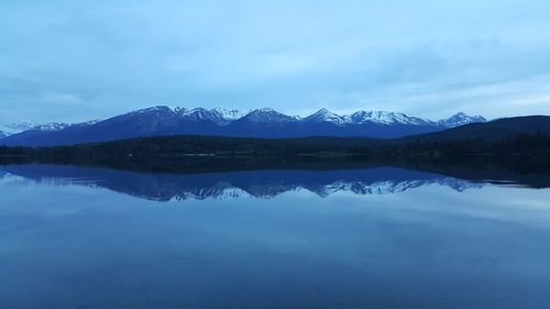 Scenic view of lake against cloudy sky