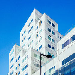 Low angle view of buildings against clear blue sky