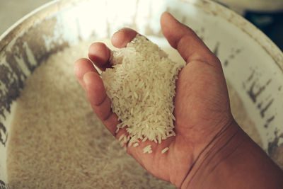 Close-up of hand holding rice