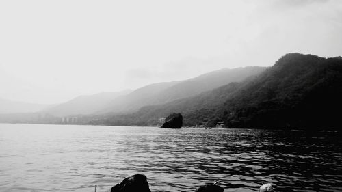 Scenic view of lake and mountains against sky