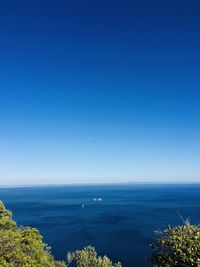 Scenic view of sea against clear blue sky