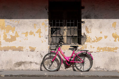 Bicycle leaning against wall