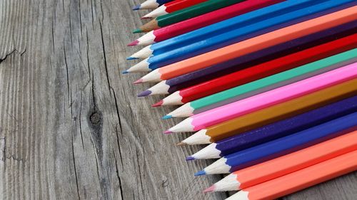 High angle view of colored pencils on wooden table