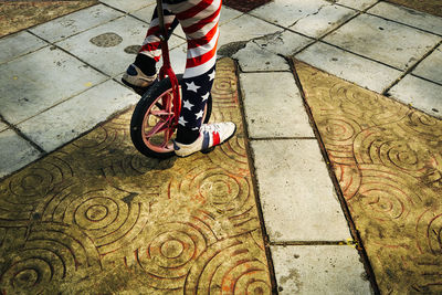 Low section of man standing on sidewalk