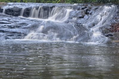 Scenic view of waterfall in forest