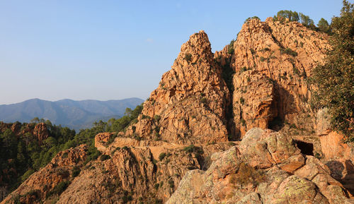 Panorama of the road called d81 in corsica france and the red rocks at sunset