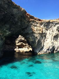 Scenic view of rocks in water against sky