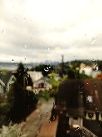Close-up of wet airplane against sky