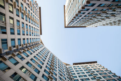 Directly below shot of buildings against clear sky