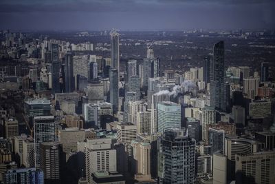 Aerial view of buildings in city against sky