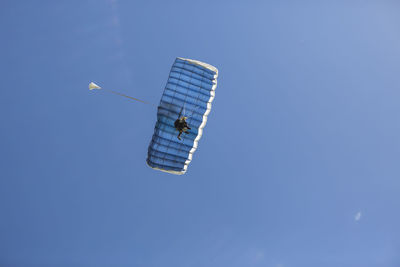 Two-person parachute descent seen from below