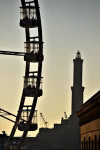 Low angle view of communications tower in city