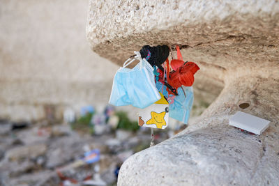 Medical mask, various object left as memory near the statue of christ the redeemer in maratea