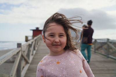 Portrait of cute girl against sky