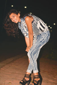 Portrait of smiling young woman standing outdoors