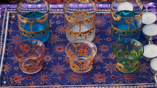 Close-up of multi colored glass on table