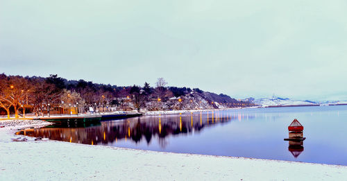 Scenic view of lake against sky during winter