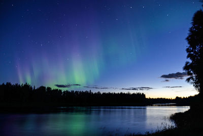 Scenic view of lake against sky at night