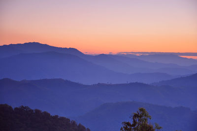 Scenic view of silhouette mountains against sky at sunset