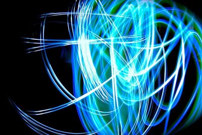 Close-up of light trails over black background
