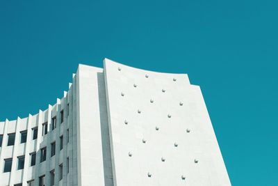 Low angle view of modern building against clear blue sky