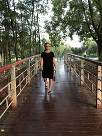 Woman walking on footbridge