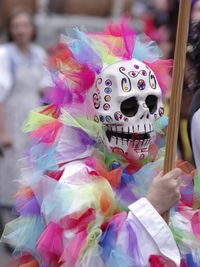 High angle portrait of woman with multi colored umbrellas