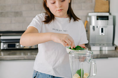 Portrait of young woman drinking water