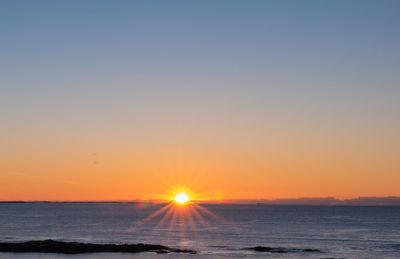 Scenic view of sea against clear sky during sunset