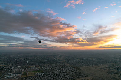 Aerial view of city against sky during sunset