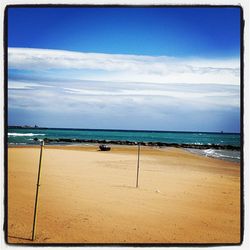 Scenic view of sea against cloudy sky