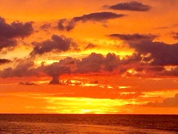 Scenic view of sea against orange sky