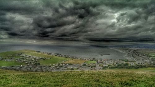 Scenic view of landscape against cloudy sky