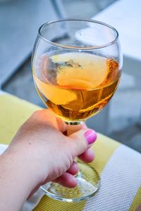 Close-up of hand holding glass of drink