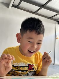 Full length of boy holding camera
