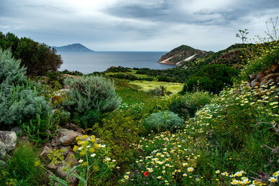 Scenic view of sea and mountains against sky