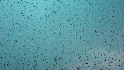 Full frame shot of raindrops on glass window