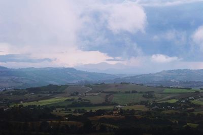 Scenic view of mountains against cloudy sky