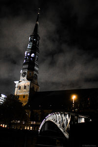 Low angle view of illuminated bridge at night