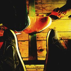 Low section of man standing on wooden floor