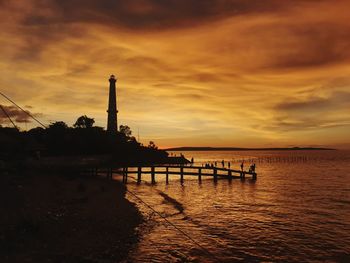 Scenic view of sea against orange sky