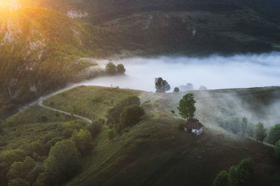 View from drone of incredible atmosphere with foggy hills at sunrise.