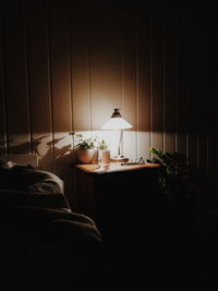 Illuminated lamp on table at home