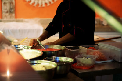 Midsection of person preparing food on table