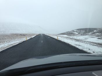 Cropped image of car on road