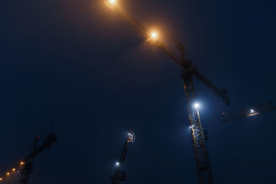 Low angle view of illuminated street light against sky at night