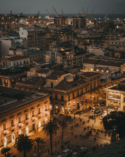 High angle view of illuminated street amidst buildings in city