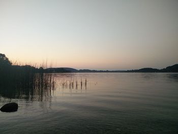 Scenic view of calm lake against clear sky