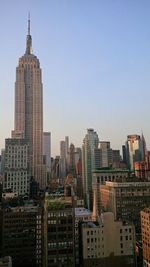 Modern buildings in city against clear sky