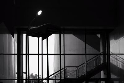 Low angle view of illuminated building seen through window